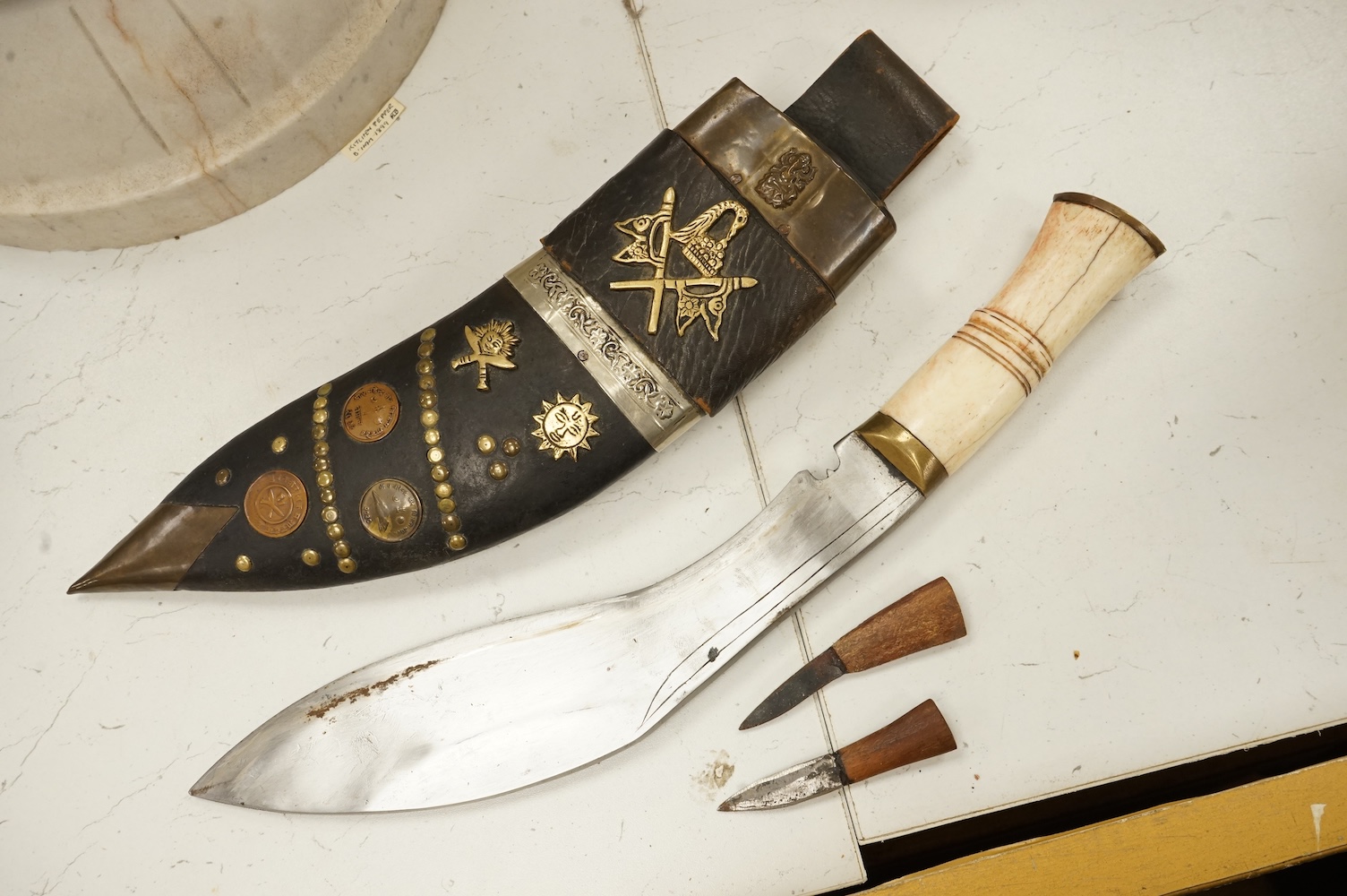 A bone handled Kukri knife, in mounted sheath